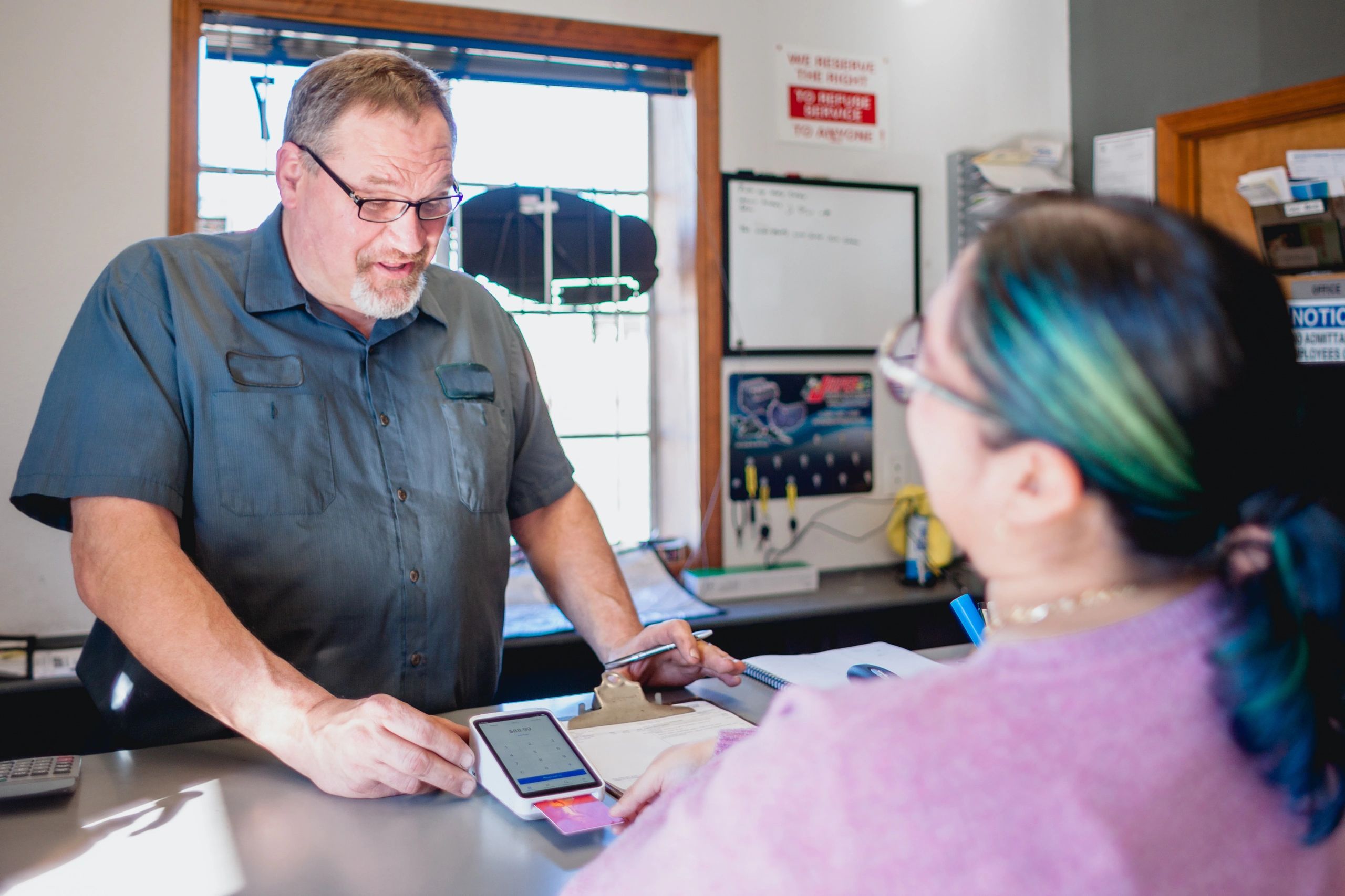 Mechanic discussing service details with a customer