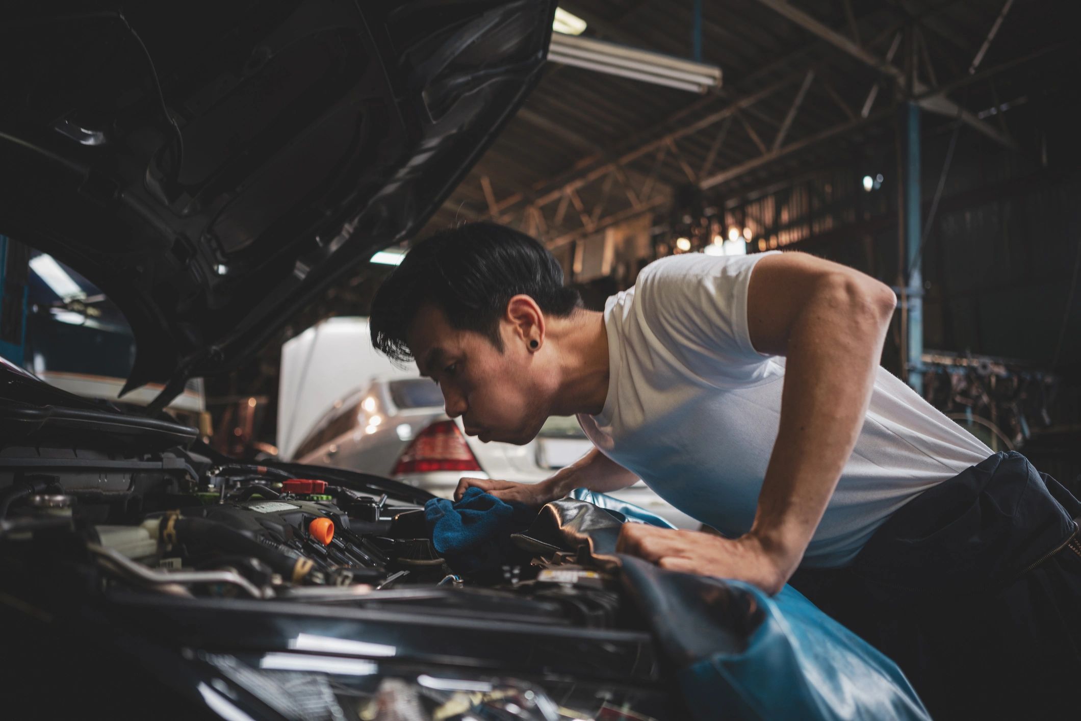 Technician examining an engine bay