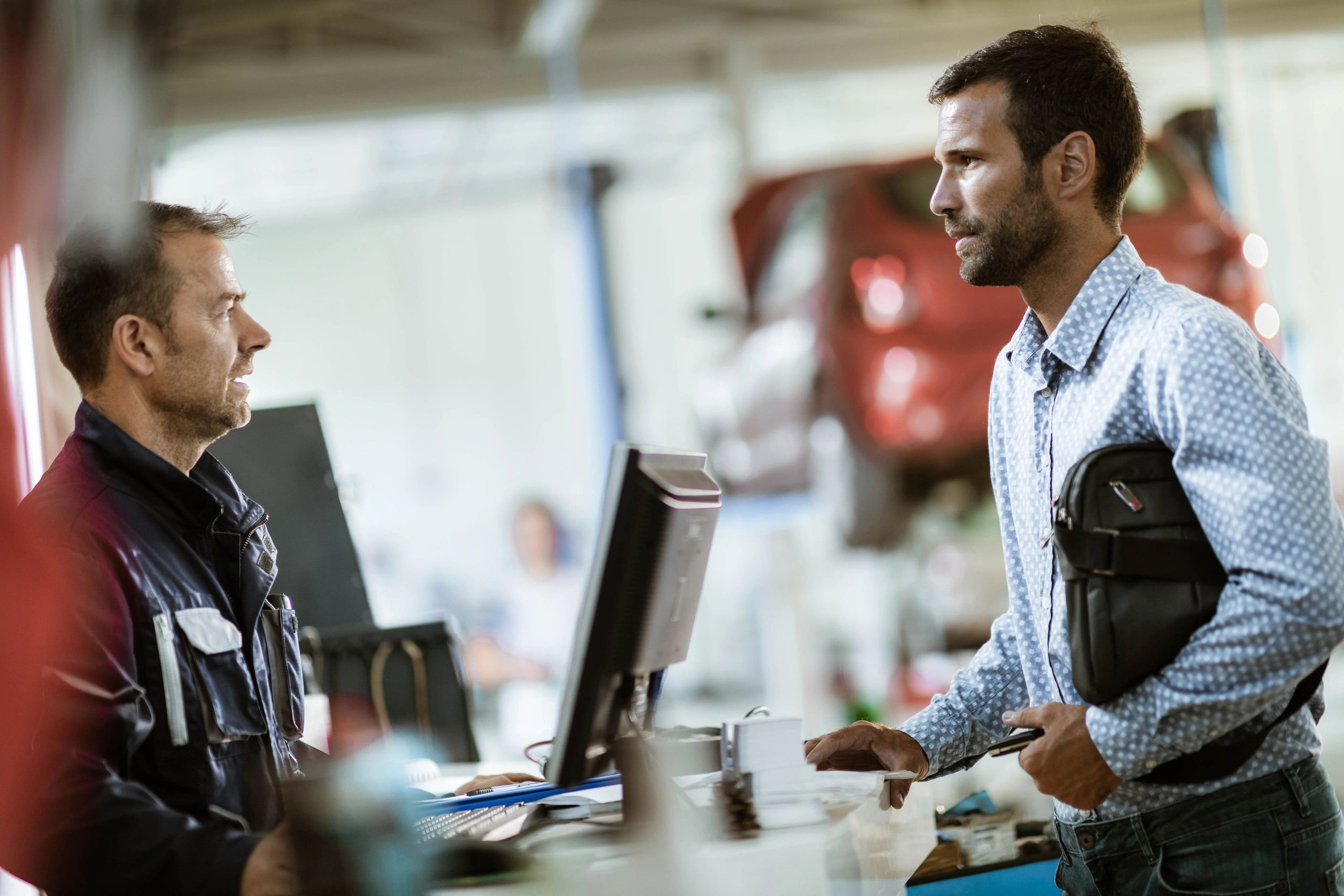 Customer speaking with a service advisor at the repair shop