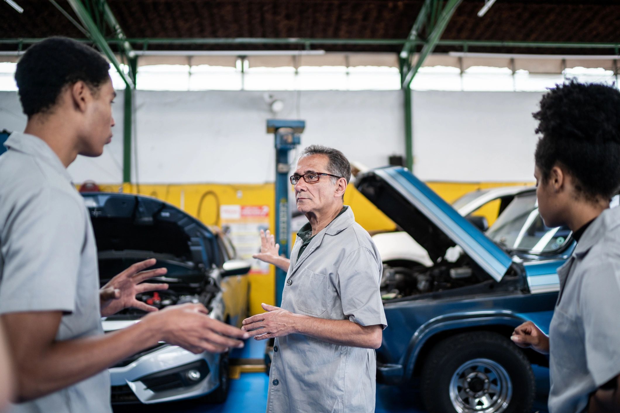 Service advisor speaking with a customer in an auto repair shop