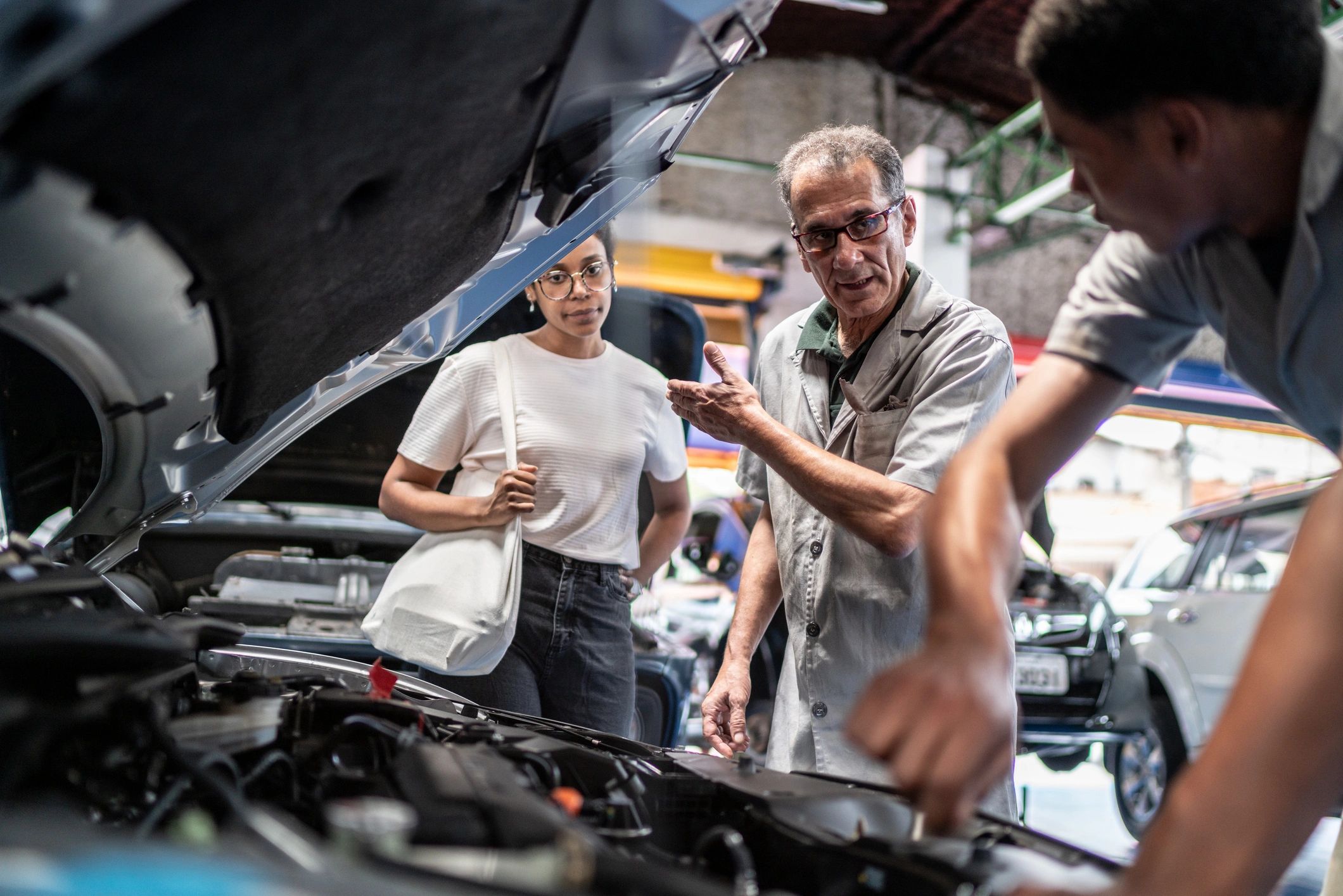 Customer and mechanic discussing service in the shop