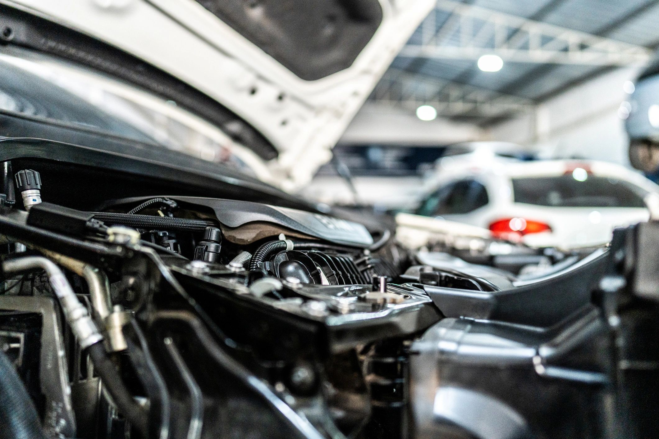 Close-up of a car engine bay at a shop