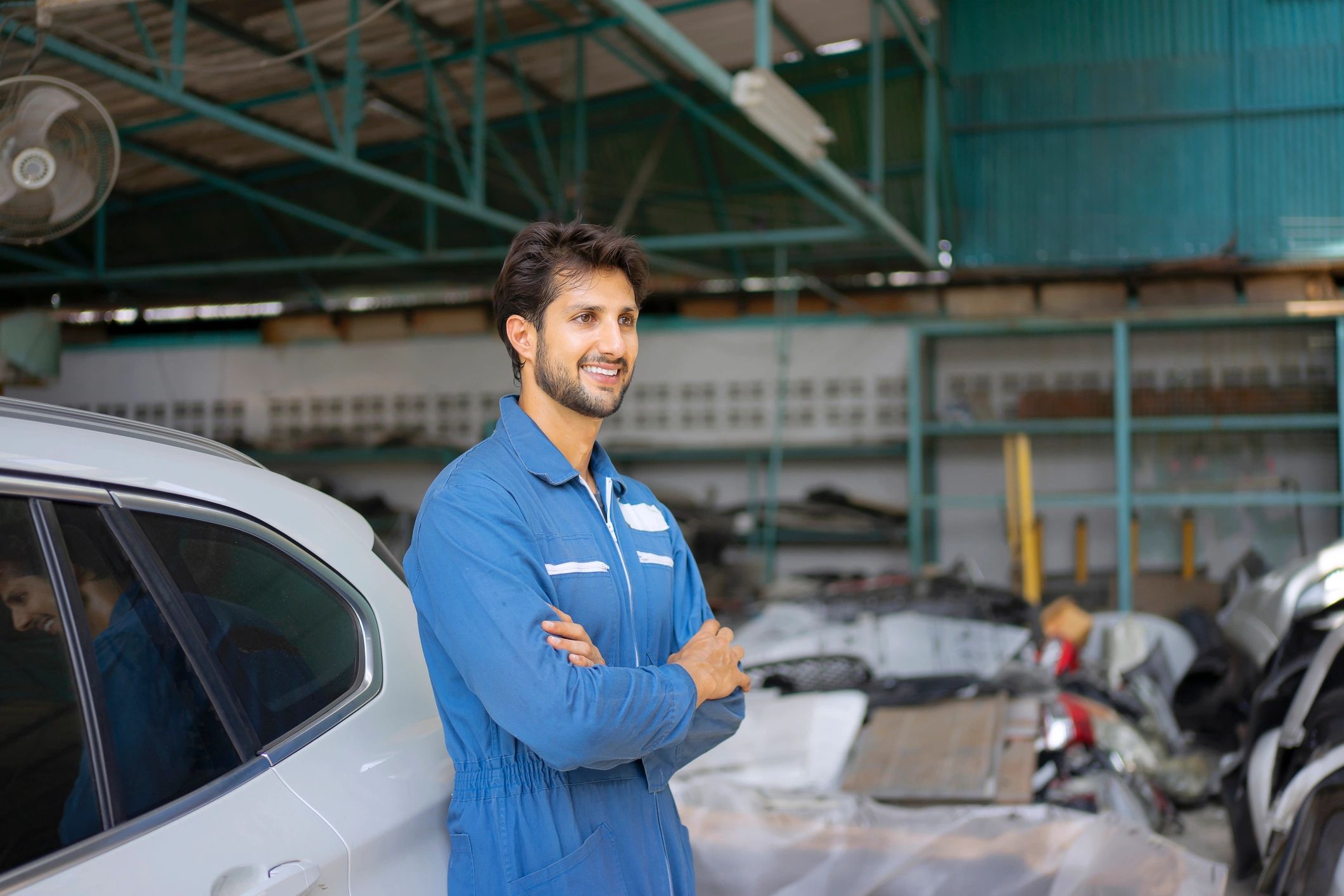 Technician inspecting a vehicle in a professional service bay