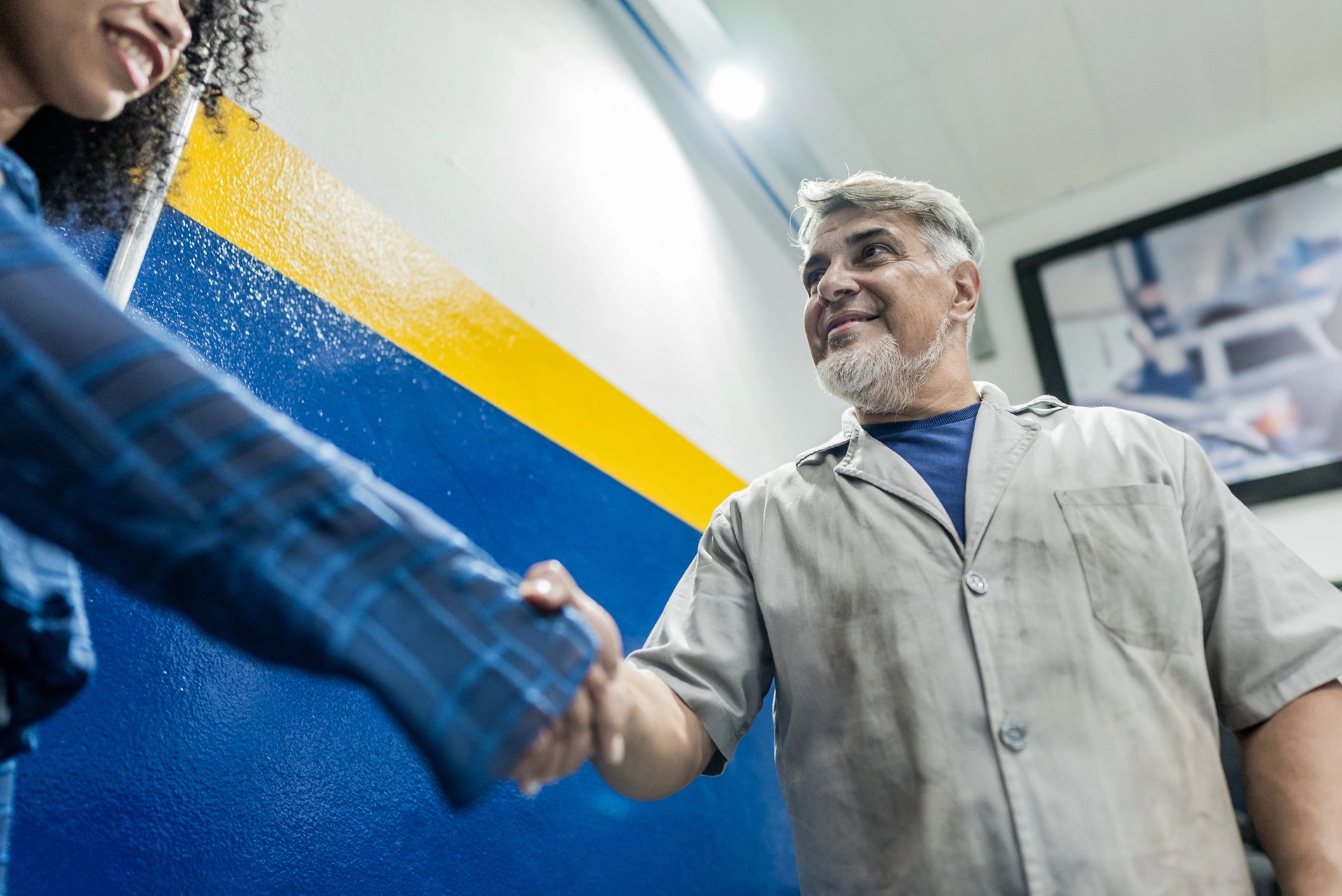 Mechanic greeting a customer at the repair shop