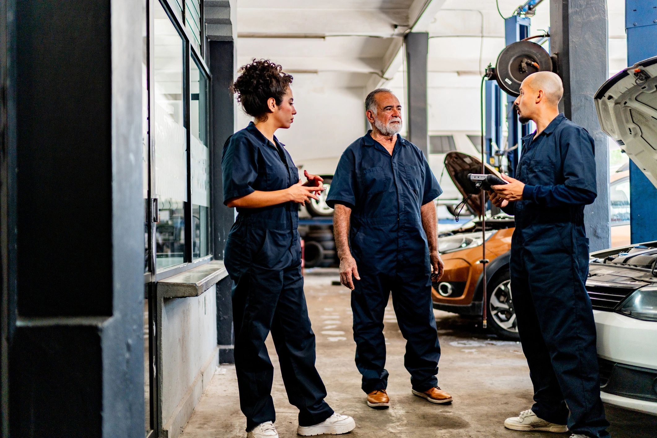 Mechanics talking together in an auto repair shop