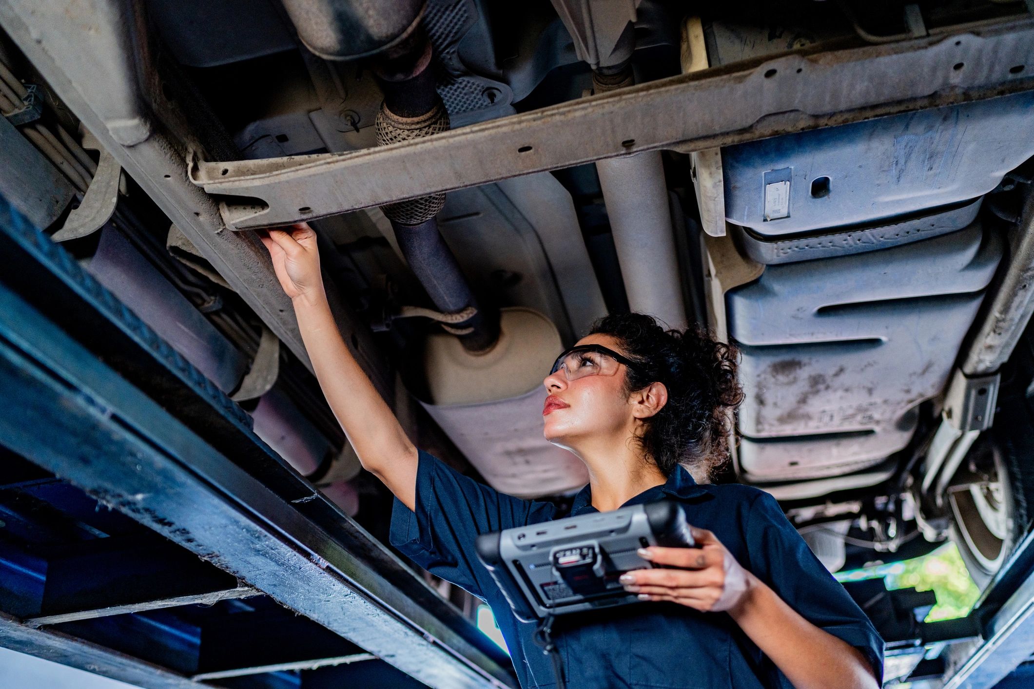 Mechanic examining a vehicle at an auto repair shop