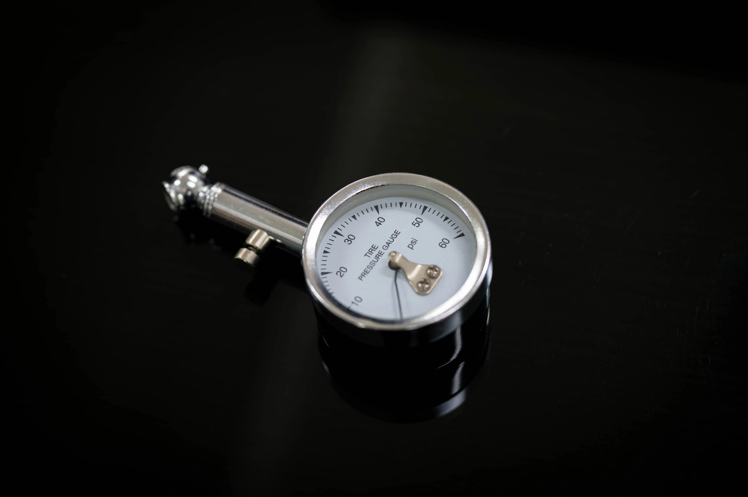 Analog tire pressure gauge showing PSI reading