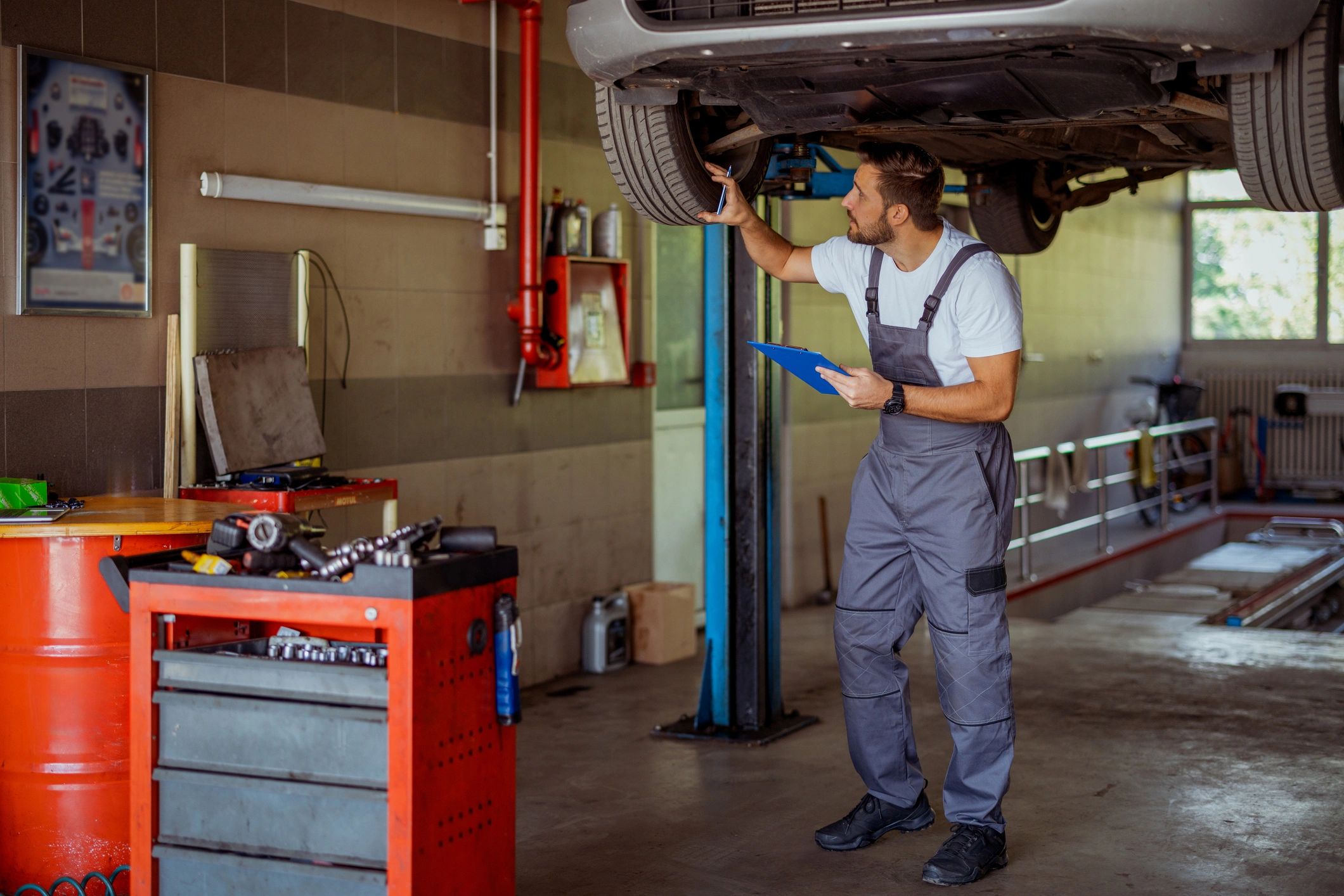 Mechanic reviewing a maintenance checklist on a clipboard