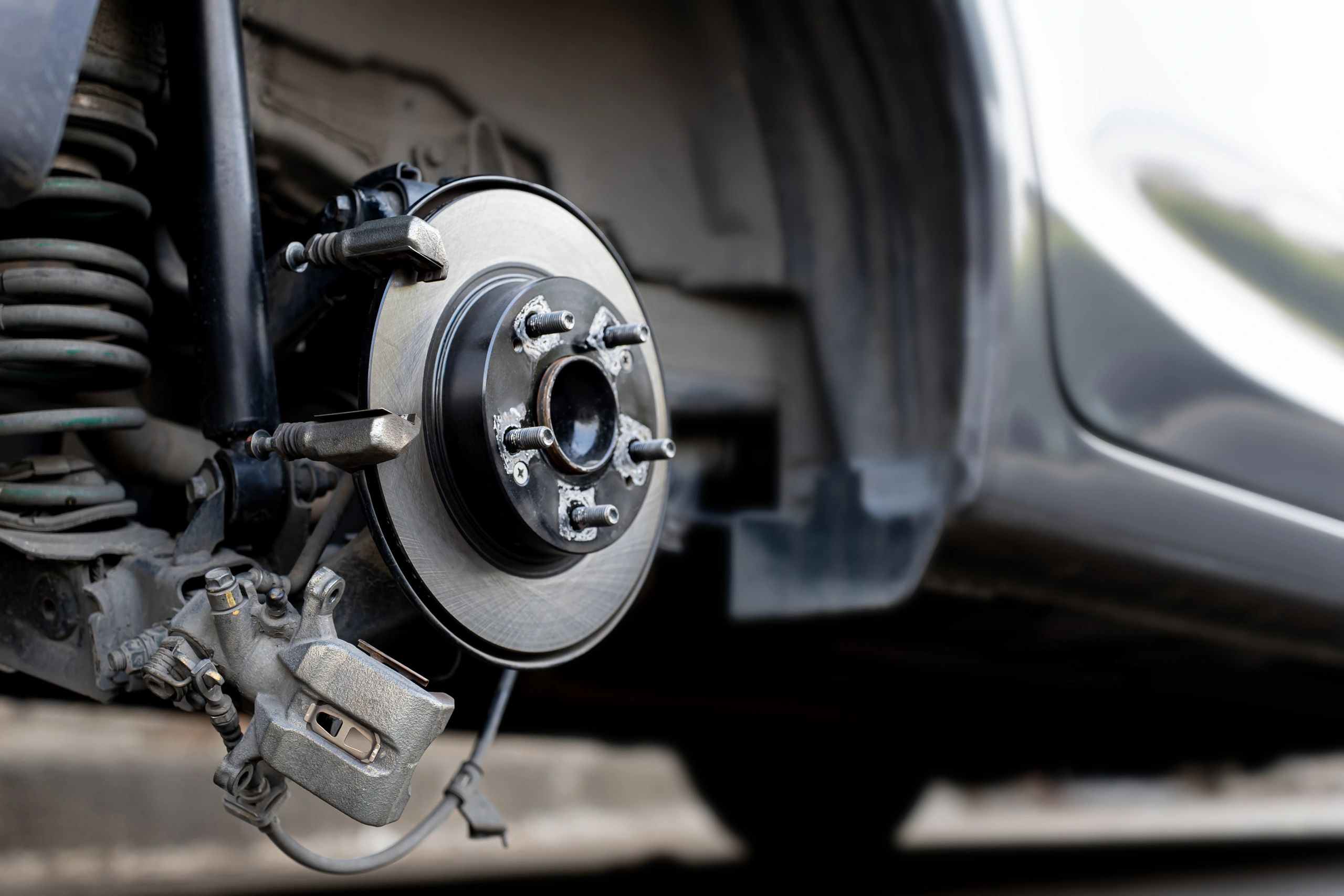 Close-up of a brake rotor and caliper during service